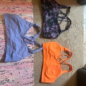 Set of Three Sports Bras - Purple, Black Floral, and Orange